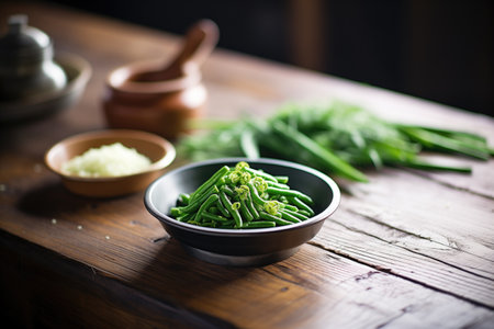 freshly steamed green beans on a rustic wooden tableの素材