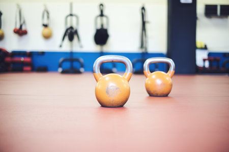 kettlebells arranged by weight on gym floorの素材