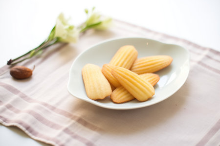 madeleines with vanilla bean pods on a linen napkinの素材