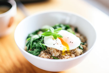 quinoa and spinach bowl with poached egg on topの写真素材
