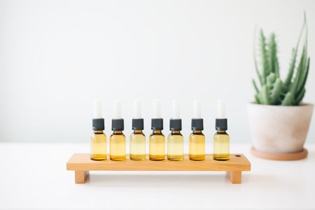 essential oil bottles stored in a minimalist wooden standの素材