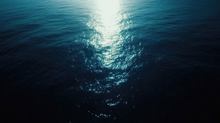 Deep blue sea gradient with glowing sunlight refracting in the water, fading to lighter hues.の素材