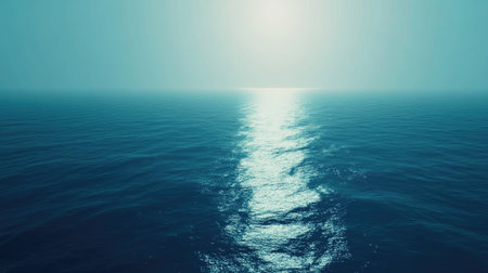 A serene blue sea gradient background transitioning from deep navy to turquoise, with gentle ripples reflecting sunlight.の素材