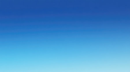 Blue sea gradient background blending oceanic shades under a cloudless, light-reflecting sky.の素材