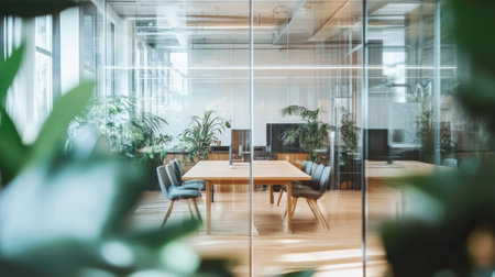 Airy office with glass-walled meeting rooms, large wooden collaboration tables, and scattered indoor plants against soft neutral tonesの素材