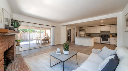 A bright and spacious modern living room showcasing comfort and style with open views to the outdoors.の素材