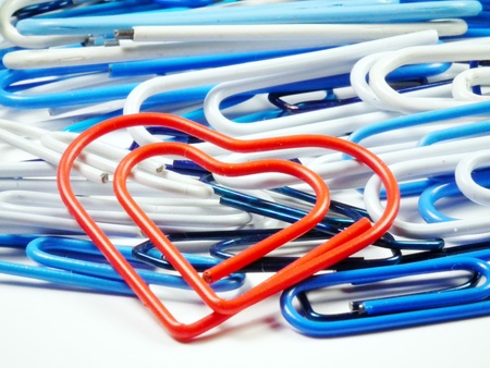 Red heart staple and other colorful staples behindの写真素材
