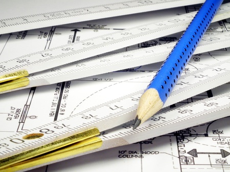 Blue pencil, wooden meter and house plan isolated on whiteの写真素材