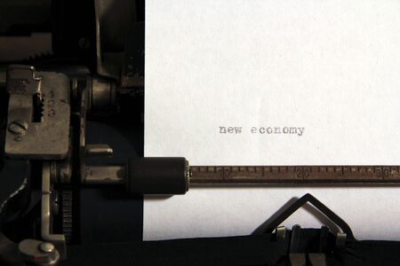 New economy words concept on old typewriter.の写真素材