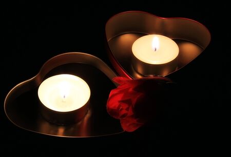Two boxes in shape of heart, candles and red rose の写真素材