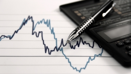 New economy; ups and downs in a graph, a pen and electronic calculator  Washed colors の写真素材