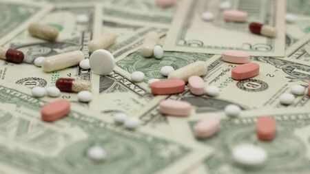 Pills on paper money の写真素材