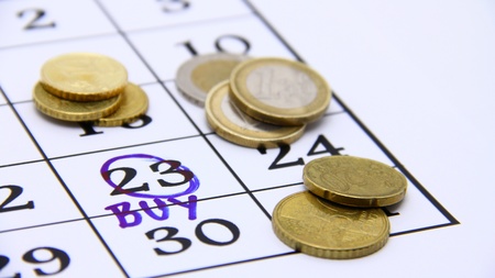Buying concept  Coins and calendar with date の写真素材