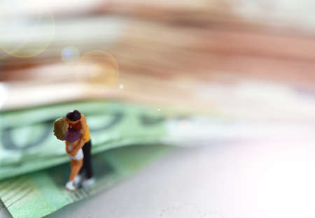 Miniature people : Traveler walking on Euro money banknote background.の写真素材