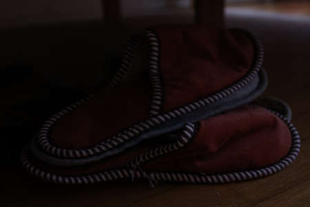 A closeup shot of a pair of red pillows on a wooden floorの写真素材