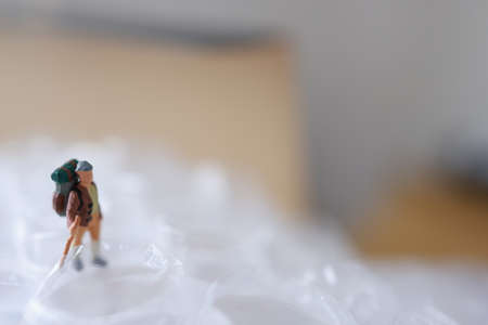Miniature people : Traveler walking on plastic bag. Travel and adventure concept.