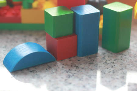 Colorful wooden building blocksle surface. Close up view.