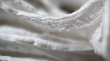 Close up white cotton fabric texture background. Macro shot, selective focus