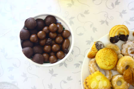 Assorted cookies and chocolate candies in a bowl