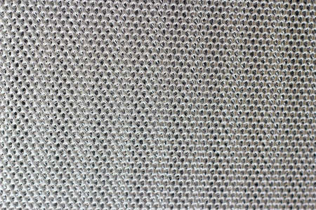 Close-up of a metal background with a lot of holes.の写真素材