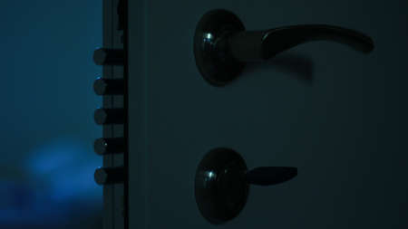 A closeup shot of a door handle on a dark blue backgroundの写真素材