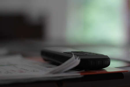Old mobile phone on a paper.の写真素材