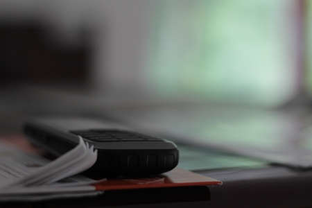 Old mobile phone on a paper.の写真素材