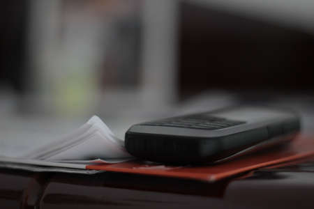 Old mobile phone on a paper.の写真素材