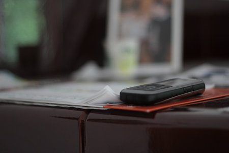 Old mobile phone on a paper.の写真素材