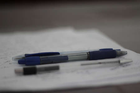 Pen and pencils on a paper. Some notices written down.の写真素材