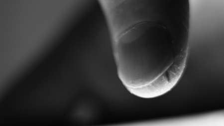 Male finger, damaged, wounded, sliding on a mobile phone.の写真素材