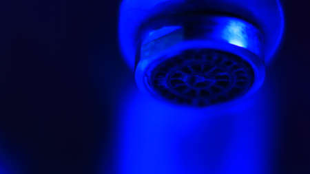 Close-up of a shower head in blue light. Selective focus.の写真素材