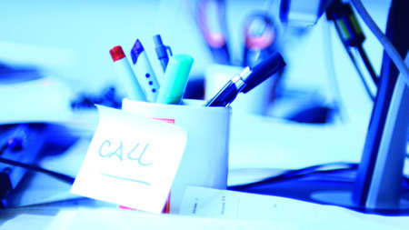 Computer, keyboard, pen, pencils, telephone in the office.