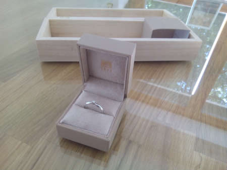 Wedding rings in a box on a wooden table in the room
