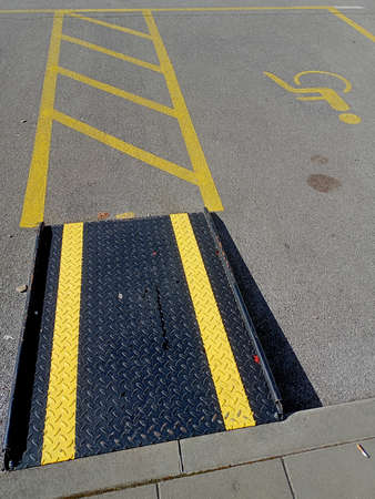 A view of the entrance to a parking lot with yellow lines.
