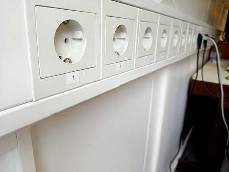 Close-up of white electrical outlet on the wall in the kitchen