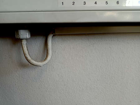 Cable connection to electrical equipment on the wall.
