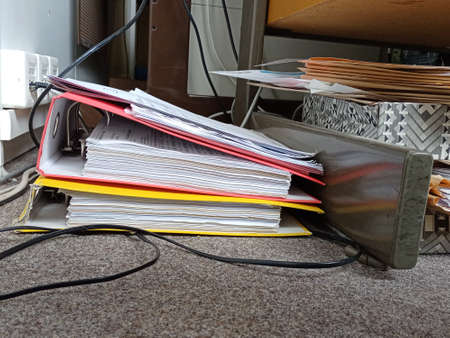 Mess of binders under desk, on floor of the office.の写真素材