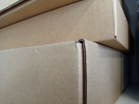 Close-up of a stack of cardboard boxes in the kitchen.の写真素材