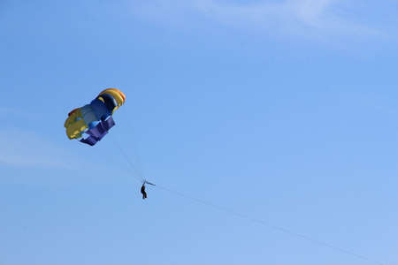 Parachutist flying in the blue sky. Blue sky background.の写真素材