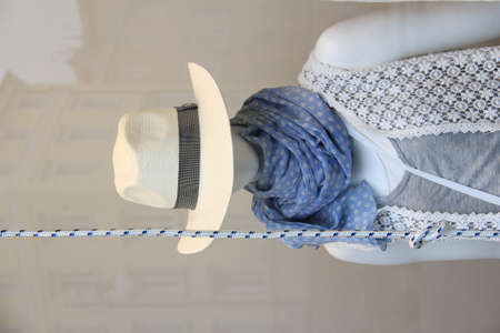 Mannequin with hat hanging indoors, closeupの写真素材
