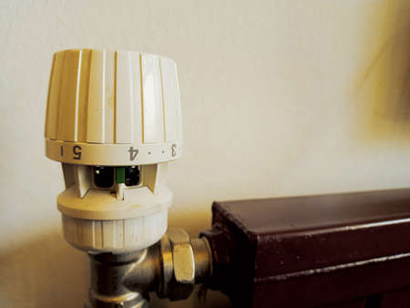 Close-up of thermostat on the radiator in a room
