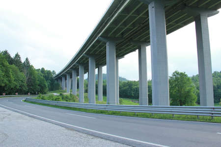 Highway viaduct in the forest. High-speed road in the forest.