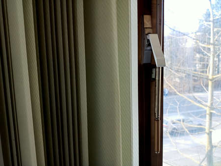 Close-up of the window blinds and a door handle.