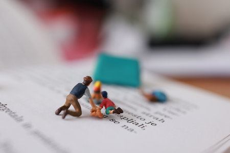 Miniature people : Businessman working on book. Image use for education concept.の写真素材