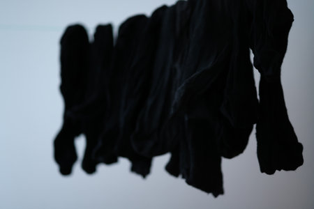 Clothes hanging on a clothesline on a grey background in the studio