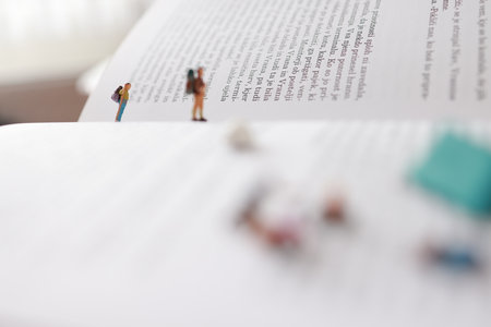 Miniature people: people reading a book. Image use for education conceptの写真素材