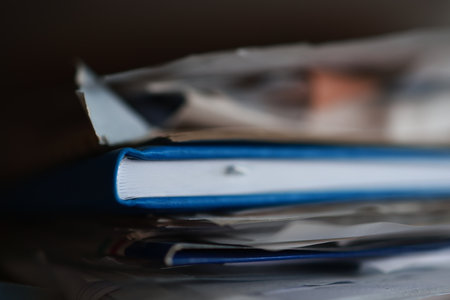Close up of a stack of documents and folders, shallow depth of field