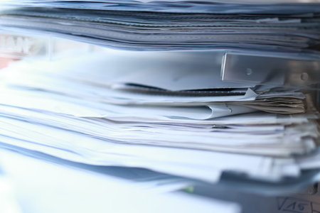 Pile of documents on the desk in office, close-up