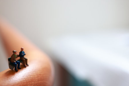 Miniature people : Couple sitting on bench.の写真素材